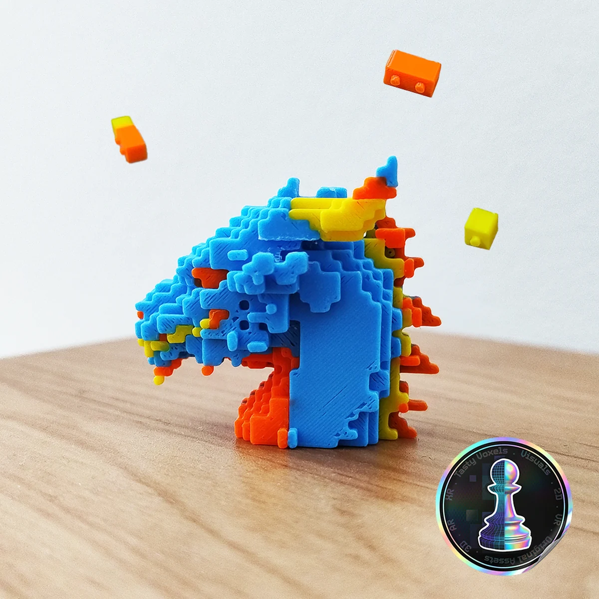 A 3D-printed VOXL brick puzzle dragon assembled on a wooden desk